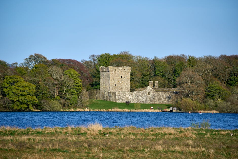 Peaceful view of medieval castle ruins surrounded by nature by Loch Leven, Scotland.